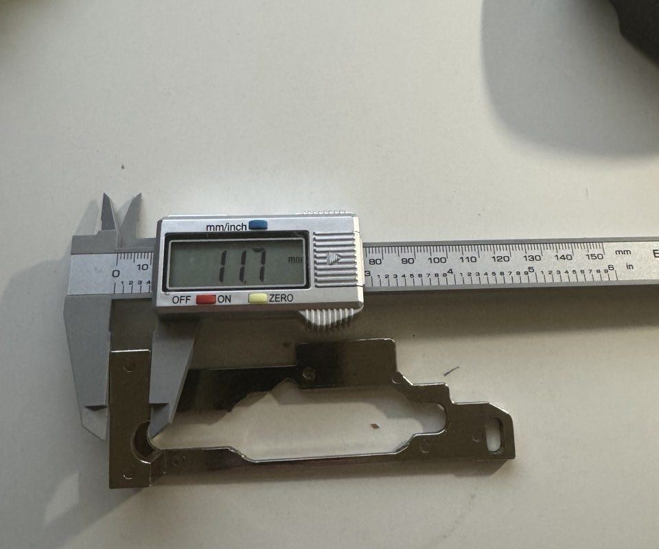 CNC metal part measured with digital caliper