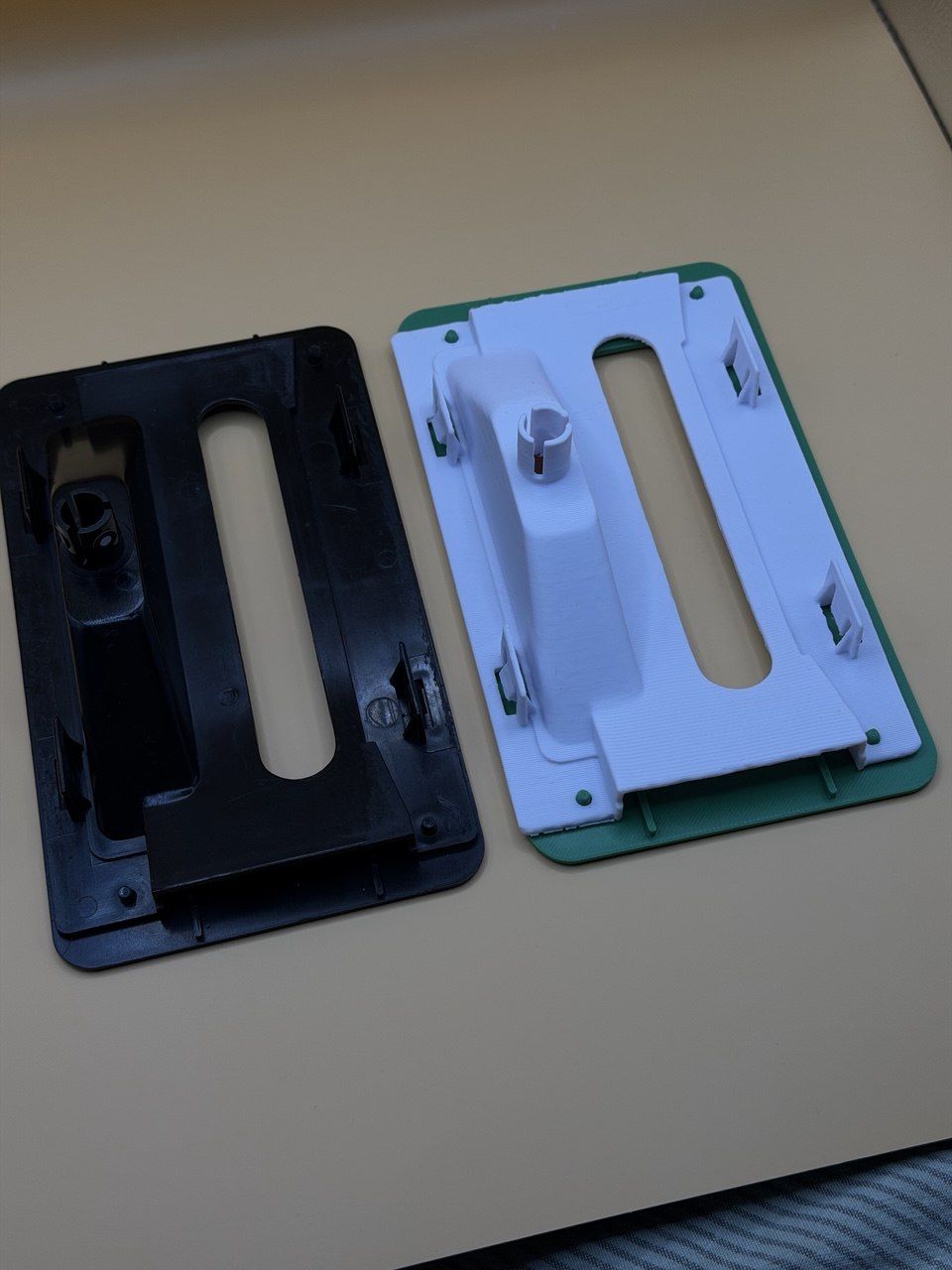Original black part and white 3D printed replacement